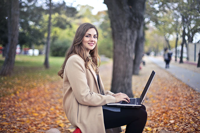 Woman on laptop outside