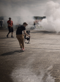 videographer moving through smoke with a camera